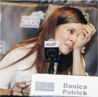  ?? DARRYL GRAHAM/ THE ASSOCIATED PRESS ?? Danica Patrick wipes away tears at a conference Friday as she announces she will end her full-time racing career after running in next year’s Daytona 500 and Indianapol­is 500.