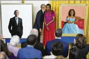  ?? ANDREW HARNIK/ASSOCIATED PRESS ?? Former President Barack Obama kisses former first lady Michelle Obama after they unveiled their official White House portraits during a ceremony Wednesday in the East Room. “Barack and Michelle, welcome home,” President Joe Biden said.