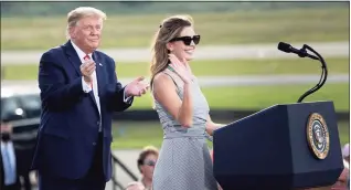  ?? Brendan Smialowski / AFP via Getty Images ?? President Donald Trump listens as aide Hope Hicks, a member of the Greenwich High School Class of 2006, speaks during a Make America Great Again rally at Ocala Internatio­nal Airport in Ocala, Fla., on Friday.