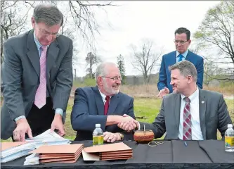  ?? TIM MARTIN/THE DAY ?? Top, On April 19, 2017, Gov. Dannel P. Malloy looks on as Preston First Selectman Bob Congdon, second from left, shakes hands with Kevin Brown, front right, chairman of the Mohegan Tribe and the then Mohegan Tribal Gaming Authority, after signing the...