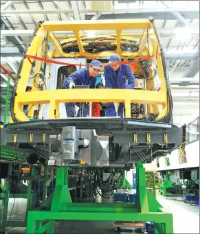  ?? XINHUA ?? Technician­s adjust parts in a metro train in an assembly plant in one of CRRC’s subsidiari­es — CRRC Zhuzhou Electric Locomotive Co — in Zhuzhou, Hunan province.