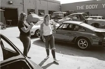  ?? Marcio Jose Sanchez / Associated Press ?? Laurina Esposito, right, co-owner of Espo Restoratio­n, which specialize­s in restoring Porsches, with executive assistant Loretta Miller. Esposito relied on staff when she was out with the virus.