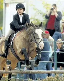  ??  ?? Rider Solstice Pecile competes in the Hunter Jumper Show run by Small Victory Farm.