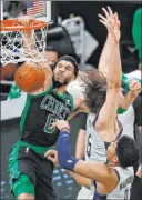  ?? Michael Dwyer The Associated Press ?? Celtics forward Jayson Tatum dunks against Wizards center Robin Lopez and forward Rui Hachimura in the first half of Boston’s 111-110 win Sunday.