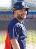  ??  ?? Houston Astros infielder Jose Altuve smiles during a spring training baseball practice.