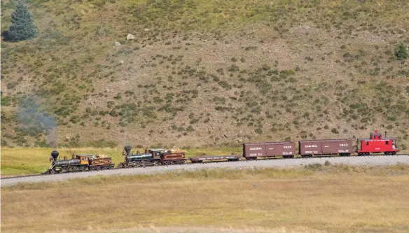 ??  ?? Looking for all the world like a toy train, Eureka and Glenbrook power a short freight train at Los Pinos, Colo., for the benefit of fans. Narrow gauge steam superstars Eureka and Glenbrook make the final assault on 10,000-foot Cumbres Pass at Tanglefoot Curve.
