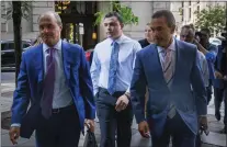  ?? ALEJANDRO A. ALVAREZ - VIA THE ASSOCIATED PRESS ?? Philadelph­ia police Officer Mark Dial, center, arrives at the Juanita Kidd Stout Center for Criminal Justice in Philadelph­ia on Sept. 19, with attorneys for a bail hearing.