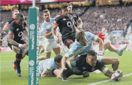  ??  ?? Nathan Hughes stretches to score England’s first try in Saturday’s 21-8 Twickenham triumph against Argentina.