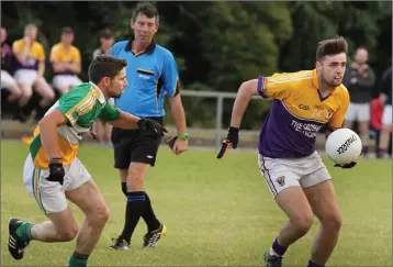  ??  ?? Glenn Rafter of Duffry Rovers moves in on Andrew Doyle (St. Patrick’s) as referee Eric Molloy looks on.