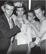  ??  ?? Original line-up: With Sham 69 singer Jimmy Pursey smoking a cigarette