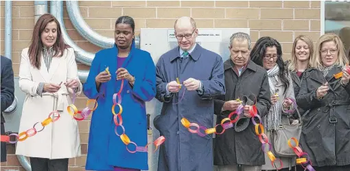  ?? ASHLEE REZIN/SUN-TIMES ?? New Moms president and CEO Laura Zumdahl (from left), Cook County State’s Attorney Kim Foxx, state Sen. Don Harmon and Oak Park Mayor Anan Abu-Taleb join dozens Friday for a ribbon-cutting for the opening of the nonprofit New Moms’ new facility in Oak Park.