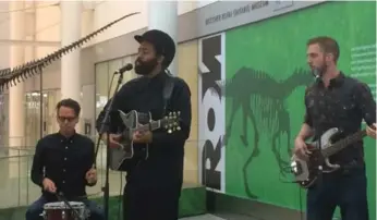  ?? DAVID RIDER/TORONTO STAR ?? Brampton-raised musician AHI (pronounced “Eye”) leads a trio in performanc­e in Pearson airport’s arrivals lounge.