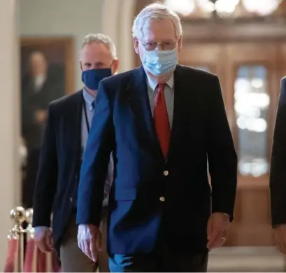  ?? Getty ImaGeS ?? READY FOR A DEAL: Senate Majority Leader Mitch McConnell, R-Ky., walks to his office from the Senate floor at the Capitol in Washington, D.C., on Friday. He said he hoped a new stimulus package to help the pandemic-battered economy would be passed soon.