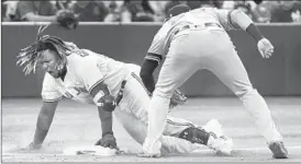  ?? FRED THORNHILL/AP ?? Vladimir Guerrero Jr. delivers a go-ahead, two-run triple in the Blue Jays’ win Saturday.