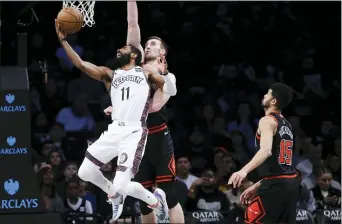  ?? FRANK FRANKLIN II — THE ASSOCIATED PRESS ?? Brooklyn’s Kyrie Irving (11) drives past Chicago’s Luke Kornet and Chandler Hutchison (15) during the first half Friday in New York.
