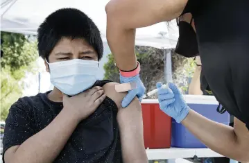  ?? IRFAN KHAN Los Angeles Times | June 2021 ?? A 12-year-old receives a COVID-19 vaccine in Los Angeles. The CDC’s bottom line: Given what’s known and not known about immunity, people who have been infected with the virus that causes COVID-19 should still get vaccinated.