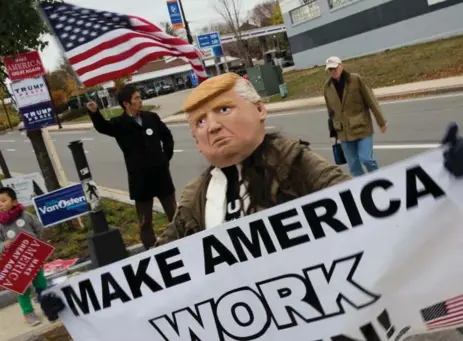  ?? DOMINICK REUTER/AFP/GETTY IMAGES ?? In Manchester, New Hampshire, a Trump supporter in costume helps his man campaign in what is now seen as a competitiv­e state for him.