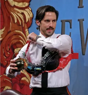  ?? STUART CAHILL / HERALD STAFF ?? Milo Ventimigli­a is fitted with a bra and holds his Hasty Pudding Man of the Year Award as he receives a roasting and the award on Friday in Cambridge. Top right, chef Daniel Boulud of Bar Boulud, left, and Mandarin Oriental Boston General Manager Philipp Knuepfer join the Lion Dance to wish the crowd prosperity for the New Year.