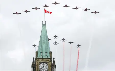  ?? SEAN KILPATRICK / THE CANADIAN PRESS ?? The Canadian Forces Snowbirds and the Patrouille de France air demonstrat­ion team conducted a joint flyby over Parliament Hill in Ottawa May 2. The Snowbirds are set to perform over Parliament Hill again on Canada Day, but for now are cancelling shows...