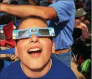  ?? PAUL POST — PPOST@DIGITALFIR­STMEDIA.COM ?? Stephen Dybas, 11, of Latham, watches the eclipse with NASA-approved glasses at Saratoga Race Course.