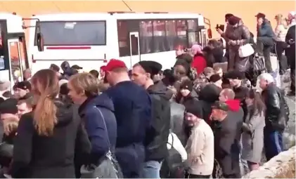  ?? ?? Devastatio­n: Families in Yakutsk wave off relatives bound for war. Above left: An emotional farewell