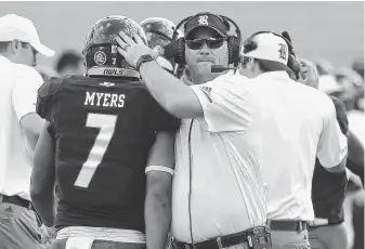  ?? Karen Warren / Staff photograph­er ?? Rice coach Mike Bloomgren gives tight end Jordan Myers a celebrator­y pat on the helmet following a fourth-quarter touchdown Saturday at Rice Stadium.