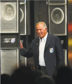  ?? Jeff Siner / TNS ?? David Pearson, standing next his plaque at the NASCAR Hall of Fame in 2011, won 105 races, second only to Richard Petty’s 200. He died Monday at 83.