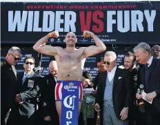  ??  ?? British boxer Tyson Fury flexes during a weigh-in ceremony Friday inLos Angeles.