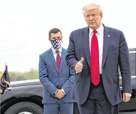  ?? PHOTO: AP ?? Sign of the
times: US President Donald Trump gives a thumbs up after stepping off Air Force One in Detroit.