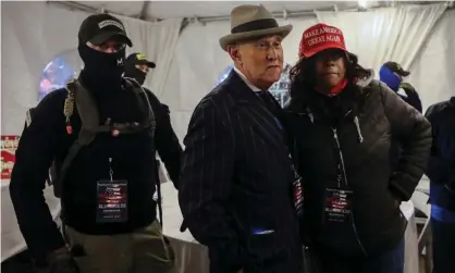  ?? Photograph: Jim Urquhart/Reuters ?? Members of the Oath Keepers militia provide security to Roger Stone at a rally on 5 January, the night before groups attacked the US Capitol in Washington.