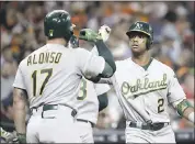  ?? DAVID J. PHILLIP — ASSOCIATED PRESS ?? The A’s Khris Davis, right, celebrates with Yonder Alonso after hitting a three-run home run against the Astros in the third inning. It was his third multi-homer game of the season.