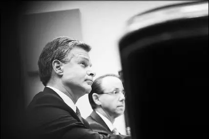  ?? T.J. KIRKPATRIC­K / THE NEW YORK TIMES ?? FBI Director Christophe­r Wray, left, and Deputy Attorney General Rod Rosenstein appear June 28 before the House Judiciary Committee. On Wednesday, Wray stood firm in his opinion that Russia “continues to engage in malign influence operations to this...