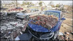  ?? GETTY IMAGES ?? Cars are covered with bricks after a tornado touched down along Chef Menture Avenue on Tuesday in New Orleans. Three tornadoes were confirmed.