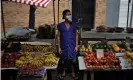  ??  ?? A fruit and vegetable seller waits for customers after street markets were reopened in Rio de Janeiro, Brazil, on 29 April 2020. Photograph: Mauro Pimentel/AFP via Getty Images