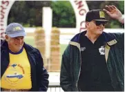  ??  ?? TOP Bathurst debut. Stan (110) in the 1954 Senior B Clubmans race at Bathurst. Elder brother Barrie is on number 111. ABOVE Father and son. Stan and Steve Bayliss spectating at the Long Track Races at Bathurst Showground in 1995.