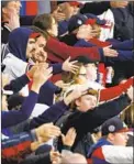  ?? Michael Zarrilli Getty Images ?? ATLANTA FANS do the tomahawk chop in Game 4. The tradition and the team nickname were defended by commission­er Rob Manfred.