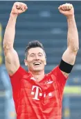  ??  ?? Winner: Robert Lewandowsk­i celebrates last night