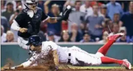  ?? CHARLES KRUPA — THE ASSOCIATED PRESS ?? Boston’s Xander Bogaerts beats the tag by Chicago White Sox catcher Omar Narvaez to score on a double by Mitch Moreland during the sixth inning at Fenway Park Thursday in Boston.