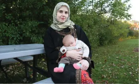  ?? MICHELLE SHEPHARD/ TORONTO STAR ?? Caitlan Coleman, the wife of Canadian Joshua Boyle, holds her infant daughter as she speaks to the Star from the grounds of a hospital in Ottawa, in her first interview since the family’s rescue from Talibanlin­ked militants in Pakistan.