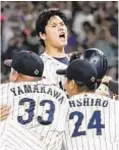  ?? AP ?? Shohei Ohtani is mobbed by Japan teammates after striking out MLB teammate Mike Trout for final out of World Baseball Classic.