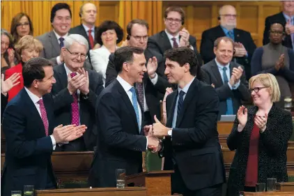  ?? CP PHOTO ADRIAN WYLD ?? Prime Minister Justin Trudeau shakes hands with the Minister of Finance Bill Morneau following the fiscal economic update in the House of Commons, in Ottawa on Wednesday.