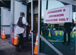  ?? DAMIAN DOVARGANES — THE ASSOCIATED PRESS FILE ?? People walk in to get a COVID-19 vaccine at the Baldwin Hills Crenshaw Plaza in Los Angeles.