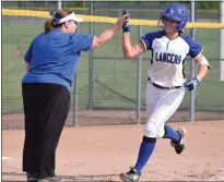  ?? ?? L’Anse Creuse’s Brooke Nadolny gets a high five from Lancers coach Lisa Downey after hitting out a 2-run homer in a 4-1win over Port Huron Northern in a Division 1softball district championsh­ip game at Anchor Bay High School in 2019.