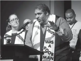  ?? Mark Humphrey/Associated Press ?? ■ In this April 2 file photo, the Rev. Dr. William J. Barber II, center, and the Rev. Dr. Liz Theoharis, left, co-chairs of the Poor People’s Campaign, speak at the National Civil Rights Museum in Memphis, Tenn. They announced the campaign is preparing for 40 days of non-violent “direct action” in about 30 states that will climax with a rally in Washington this June. The organizati­on is the rekindling of the campaign to help poor people that the Rev. Martin Luther King Jr. was working on when he was killed April 4, 1968, in Memphis.