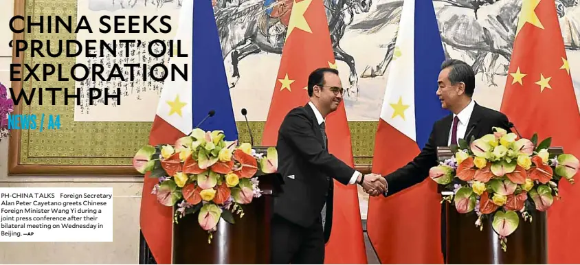  ?? —AP ?? PH-CHINA TALKS Foreign Secretary Alan Peter Cayetano greets Chinese Foreign Minister Wang Yi during a joint press conference after their bilateral meeting on Wednesday in Beijing.