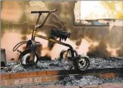  ?? Katie Falkenberg Los Angeles Times ?? A TRICYCLE at a home destroyed by the Woolsey fire, which also claimed movie sets and ranches.