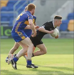  ??  ?? Newtown’s Ross Davis goes past Carnew’s Paul Nolan.