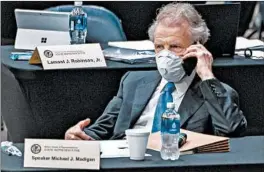  ?? JUSTIN L. FOWLER/THE STATE JOURNAL-REGISTER ?? Speaker Michael Madigan talks on his cellphone from his desk during an extended session of the Illinois House at the Bank of Springfiel­d Center in Springfiel­d in May.