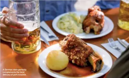  ??  ?? A German stein perfectly complement­s the local delicacy of pork knuckle.