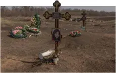  ?? ?? The graves of the victims of the Russian strike that hit a cafe last year, at a cemetery in the village of Groza, Kharkiv region, amid the Russian invasion of Ukraine.